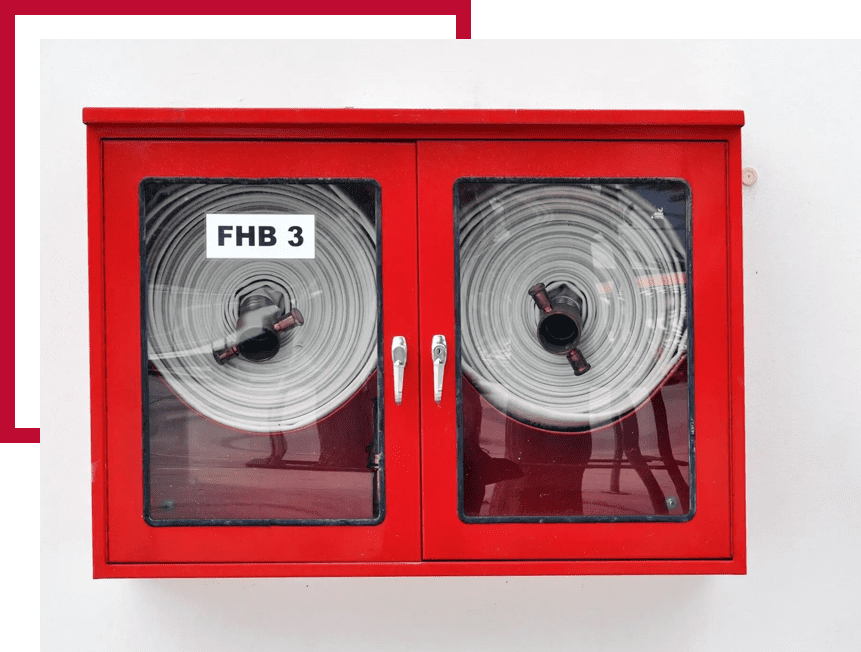 Fire hydrant and red fire hose cabinet on white cement wall